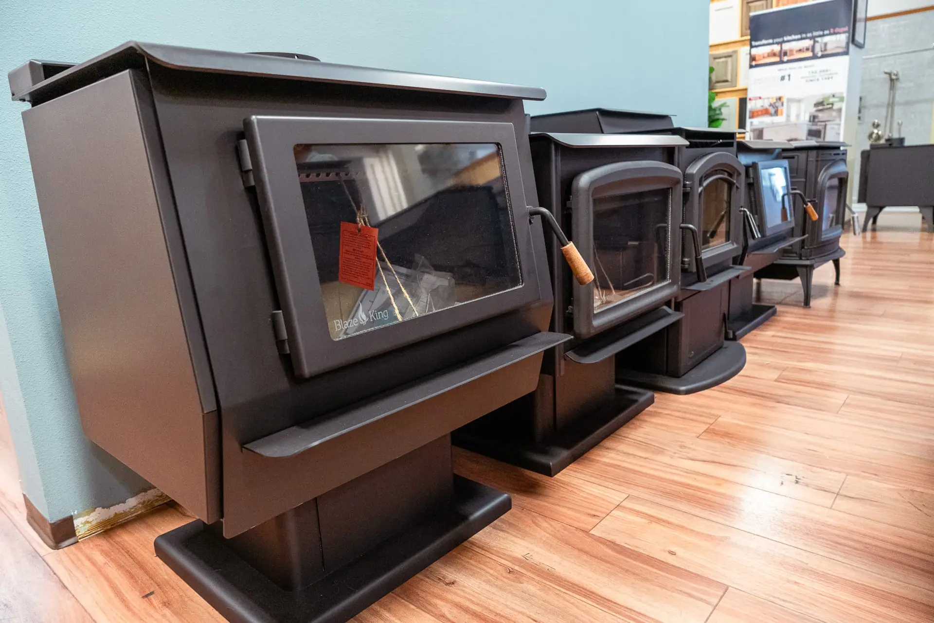 A row of Blaze King wood stoves on display.
